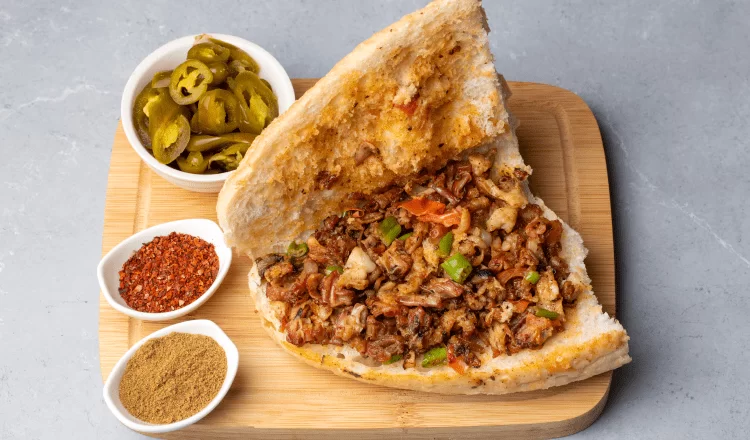 half bread kokorec with various spices and pickles