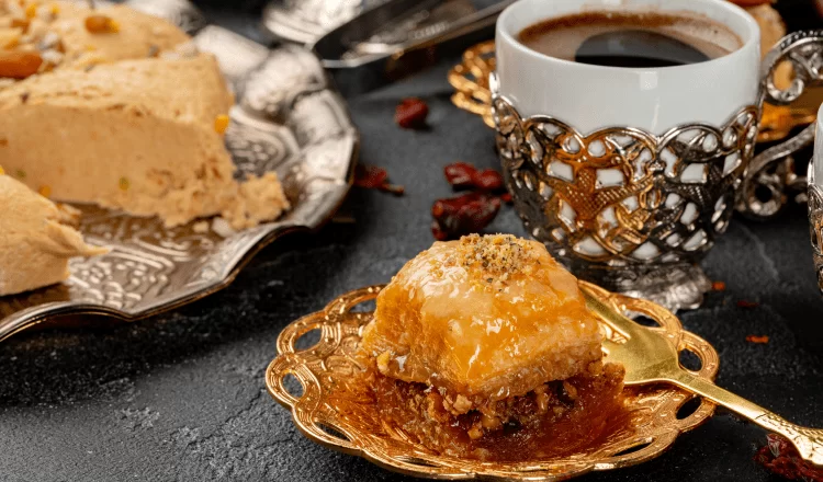 Slice of baklava standing with traditional Turkish coffee