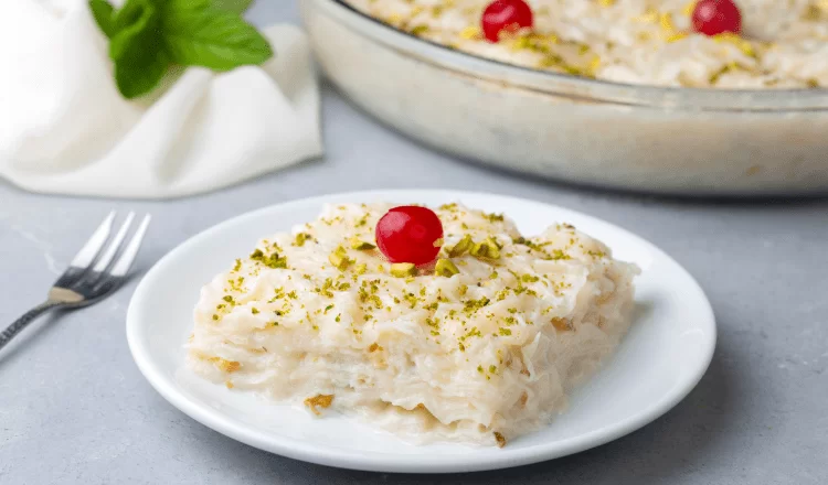 A plate of Gullac dessert with cherries on top