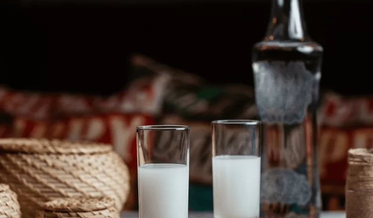 Two glasses of raki standing on the tavern table